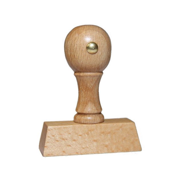 Holzstempel mit Text: Bezahlt  